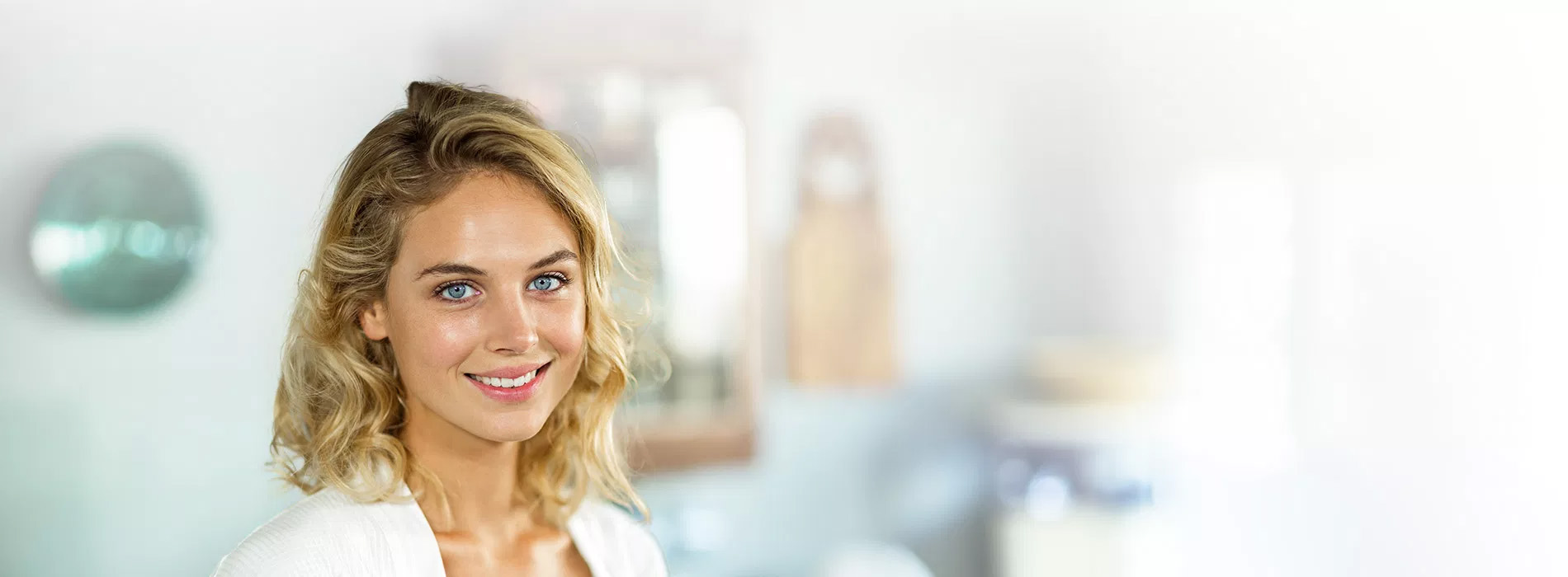 A woman with blonde hair smiles at the camera.